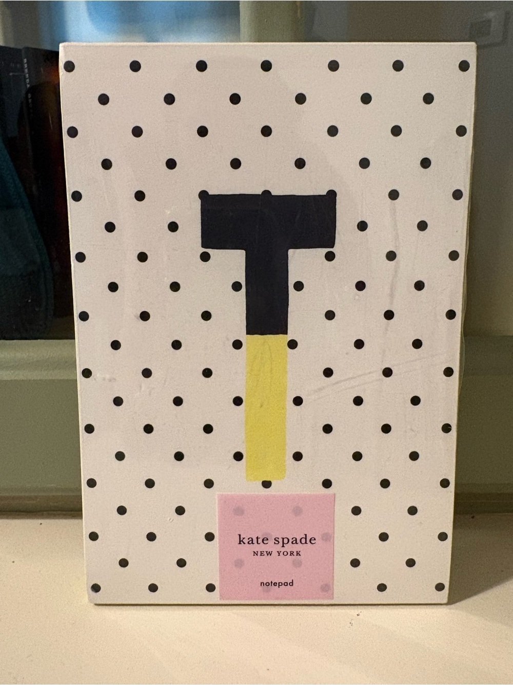 kate spade white notepad with black polka dots and yellow hammer graphic